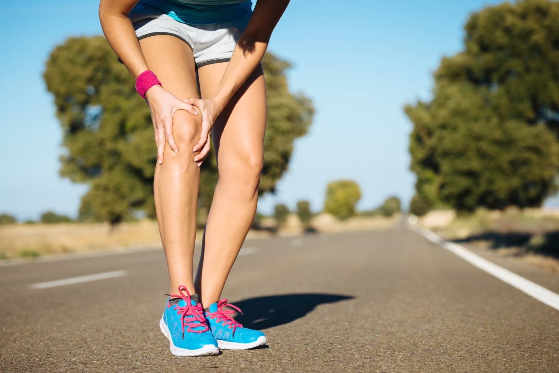 Runner with knee pain on a road