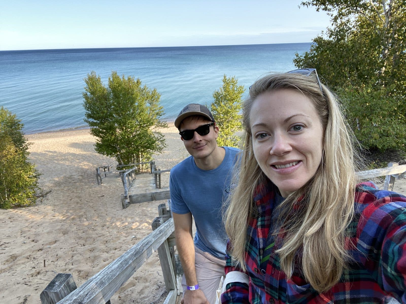 Drs. Justin and Christie Smith with backpacks on a lakeshore trail