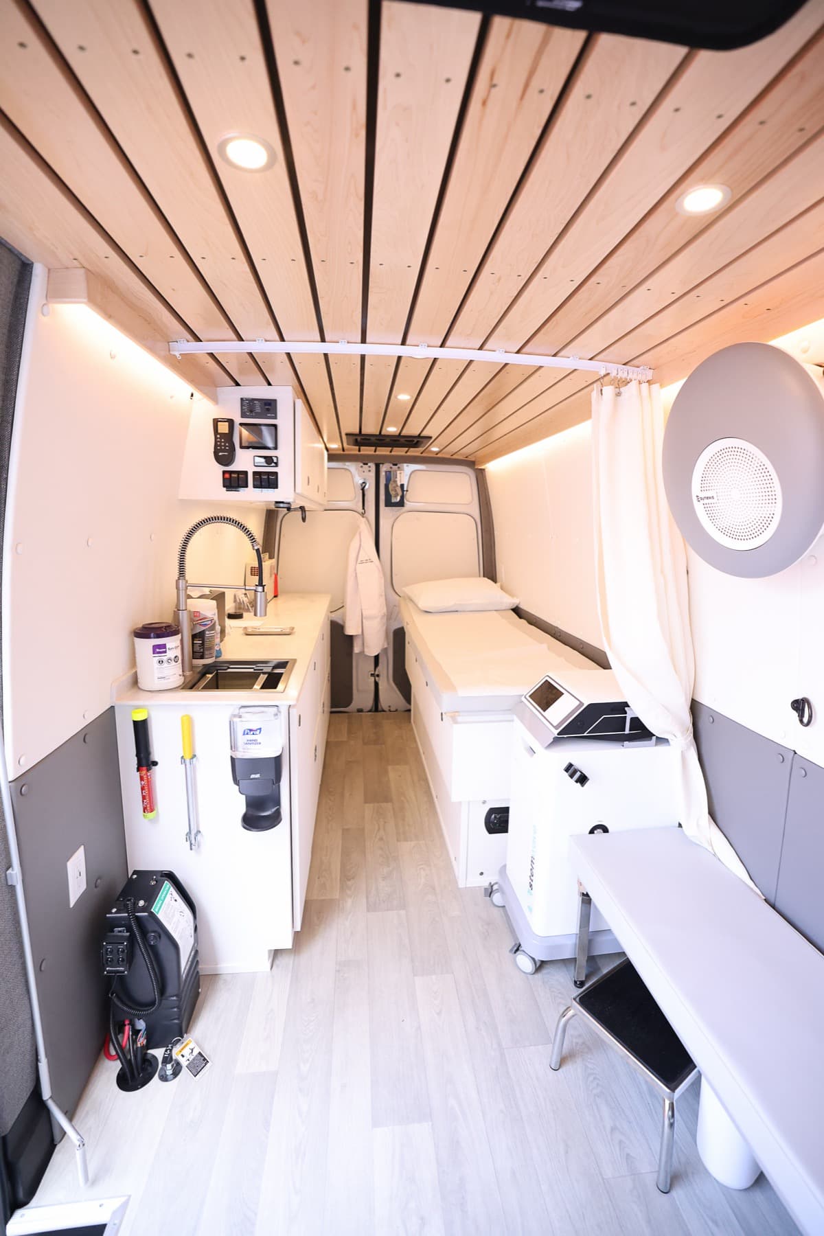 Interior of the Journey Orthopaedic Institute Mobile Medical Unit, with exam table, sink, and equipment